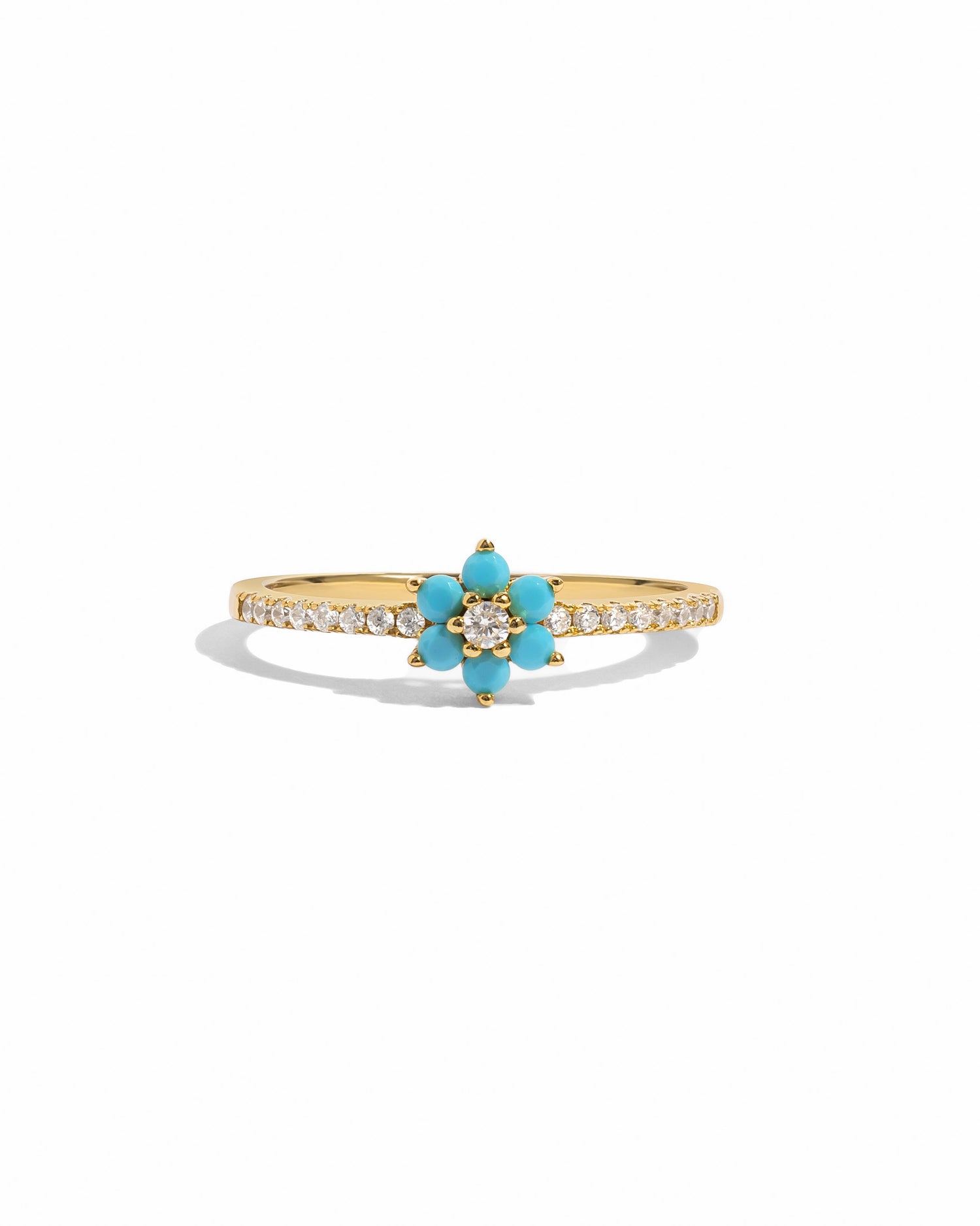 Gold Sami Jewels turquoise flower ring with intricate floral design on a white background