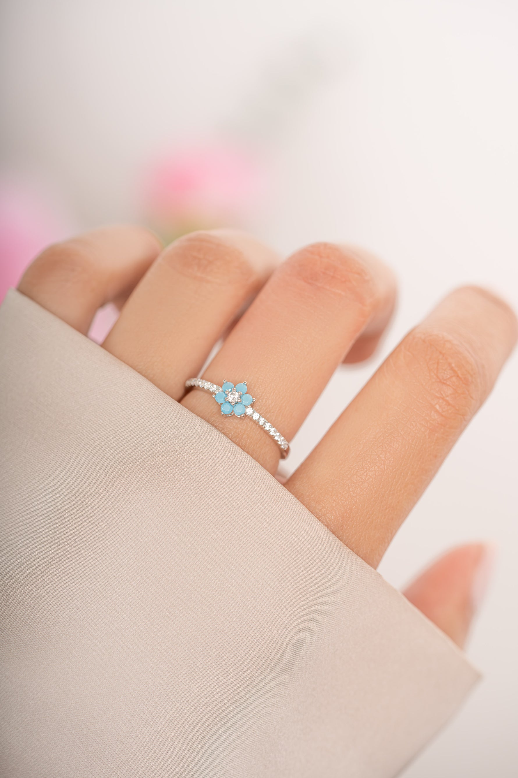 Turquoise flower ring by Sami Jewels featuring sterling silver band and detailed turquoise flower design.