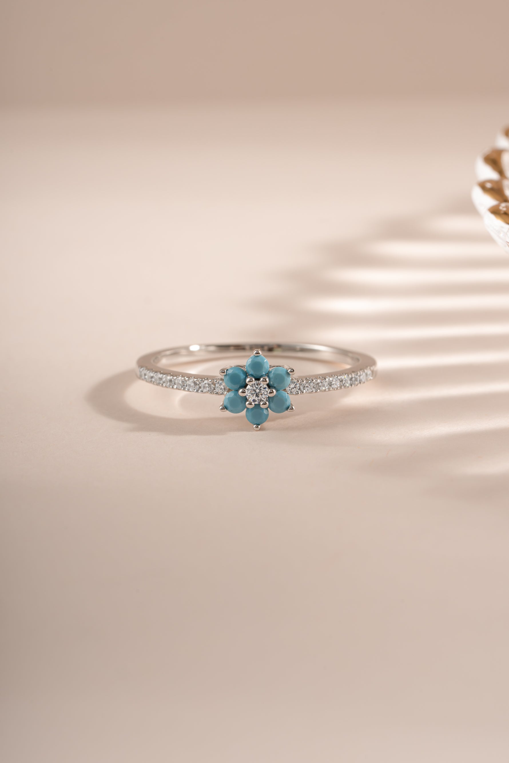 Sterling silver turquoise flower ring by Sami Jewels featuring a vibrant turquoise flower design on a polished silver band.