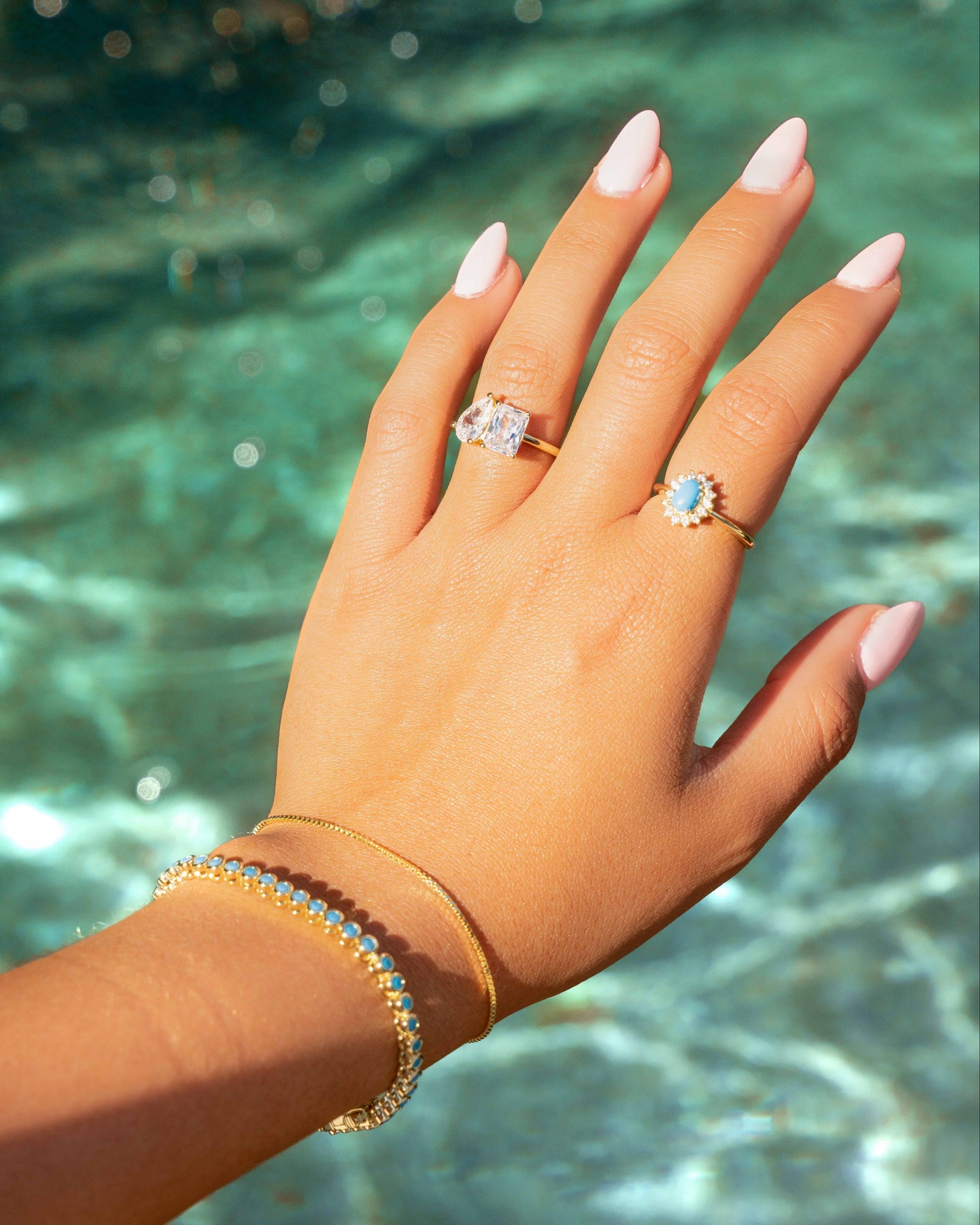Sami Jewels Layla turquoise halo ring with gold band, featuring a central turquoise gemstone and intricate gold detailing.