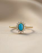 Close-up of Sami Jewels Layla Turquoise Ring featuring an oval turquoise gemstone with a halo setting.