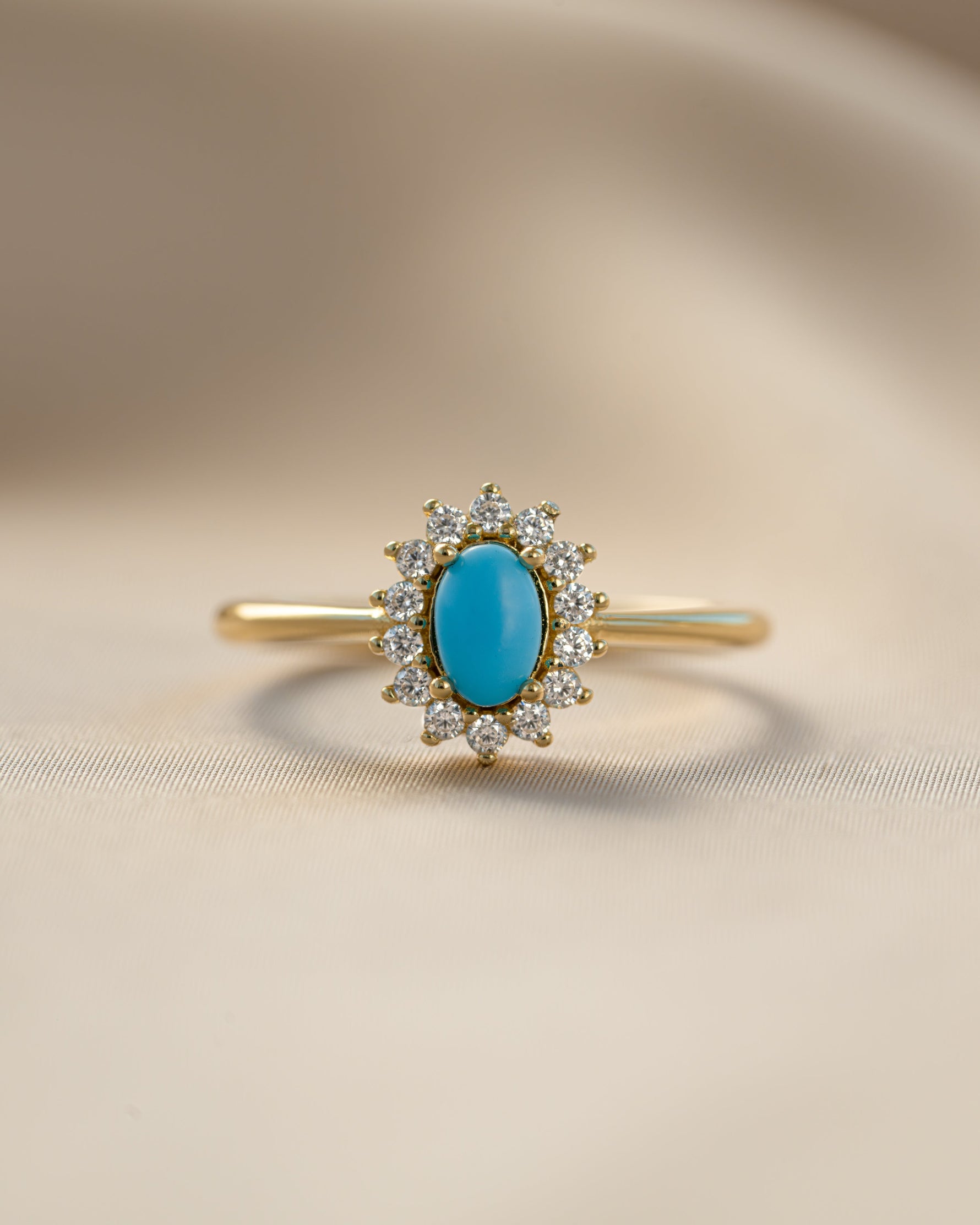 Close-up of Sami Jewels Layla Turquoise Ring featuring an oval turquoise gemstone with a halo setting.