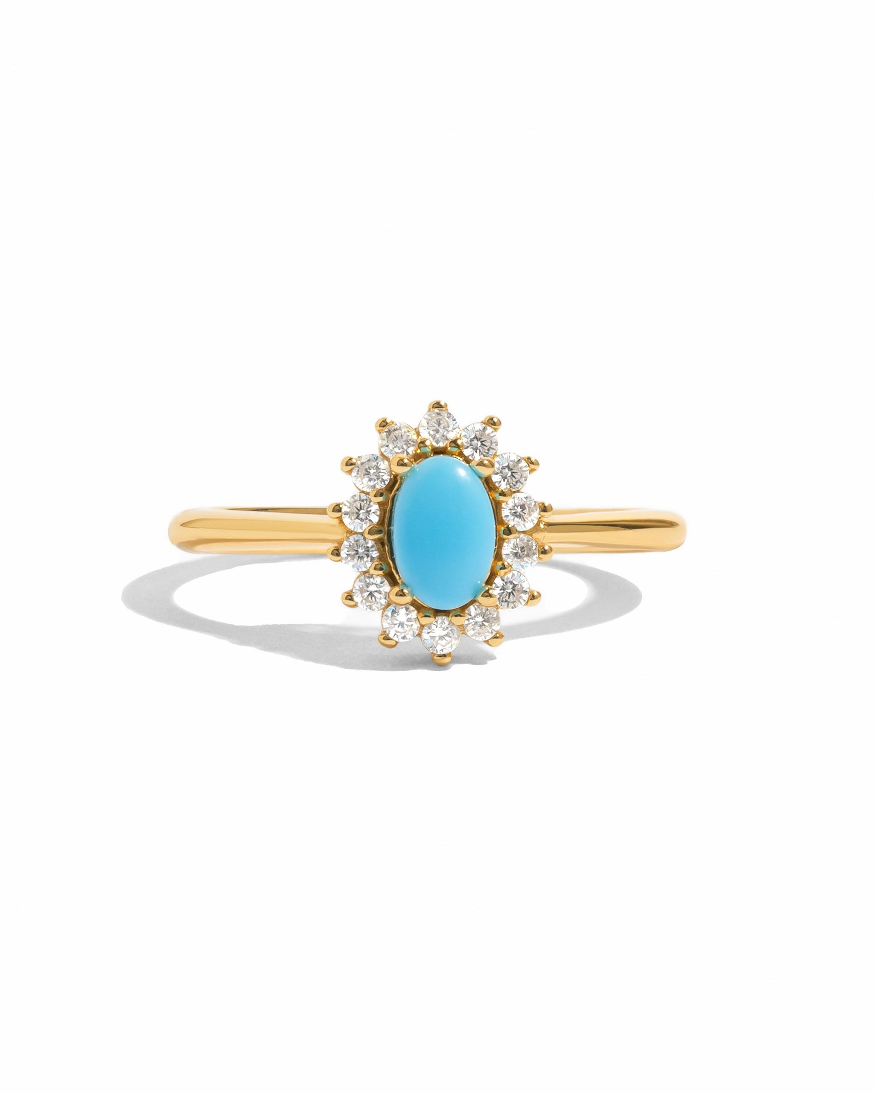 Sami Jewels Layla turquoise oval halo ring with gold band on white background, showcasing vibrant turquoise gemstone and elegant design.