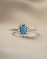 Sami Jewels Layla turquoise oval halo ring with sterling silver band, front view showcasing vibrant turquoise gemstone.