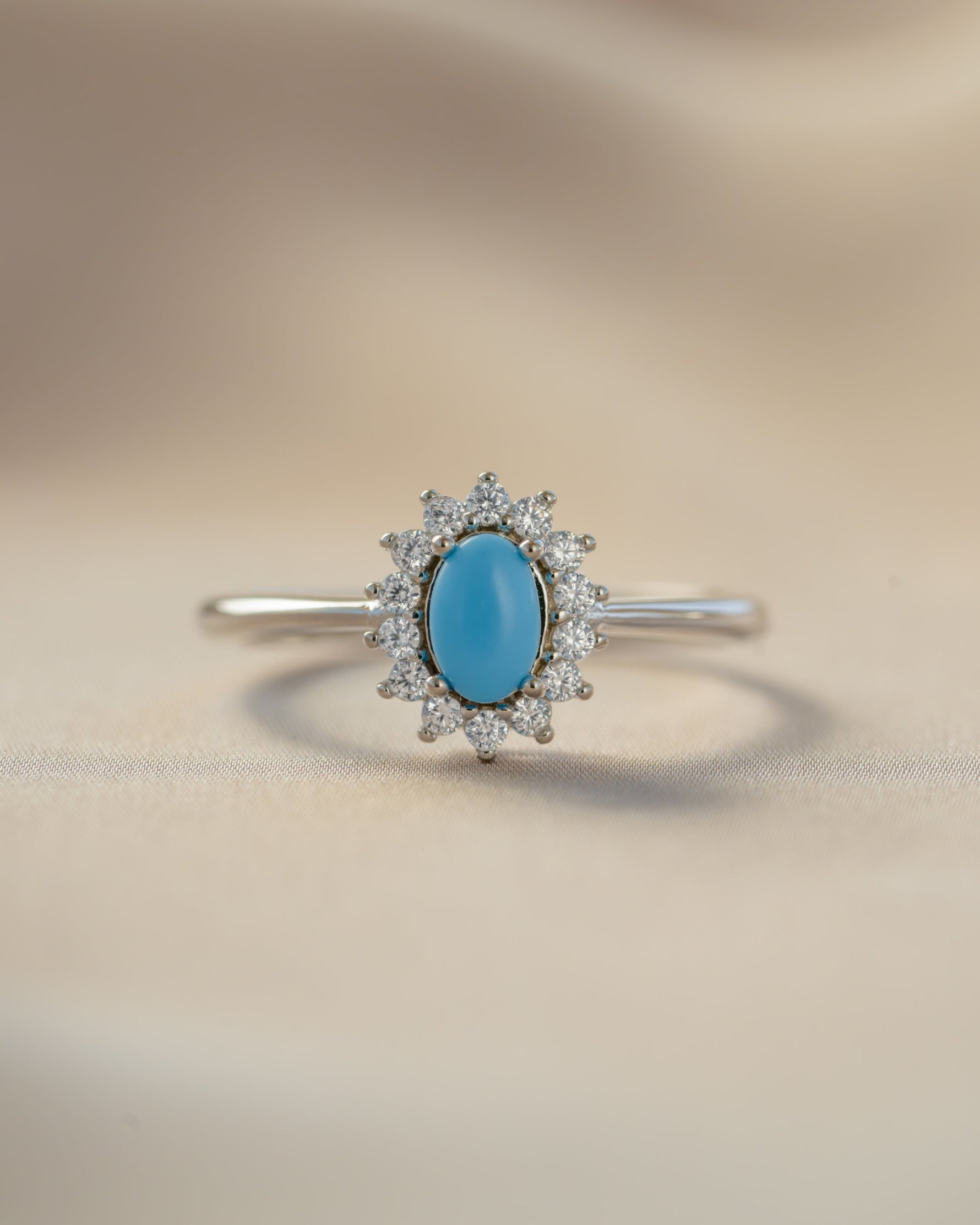 Sami Jewels Layla turquoise oval halo ring with sterling silver band, front view showcasing vibrant turquoise gemstone.