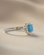 Side view of Sami Jewels Layla Turquoise Ring featuring an oval turquoise gemstone with halo setting in sterling silver.