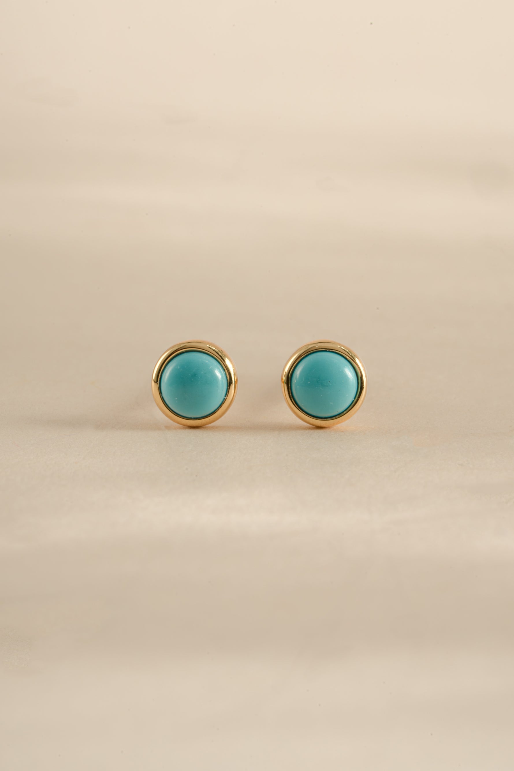 Gold turquoise stud earrings by Sami Jewels showing front view of vibrant turquoise stones on gold setting.
