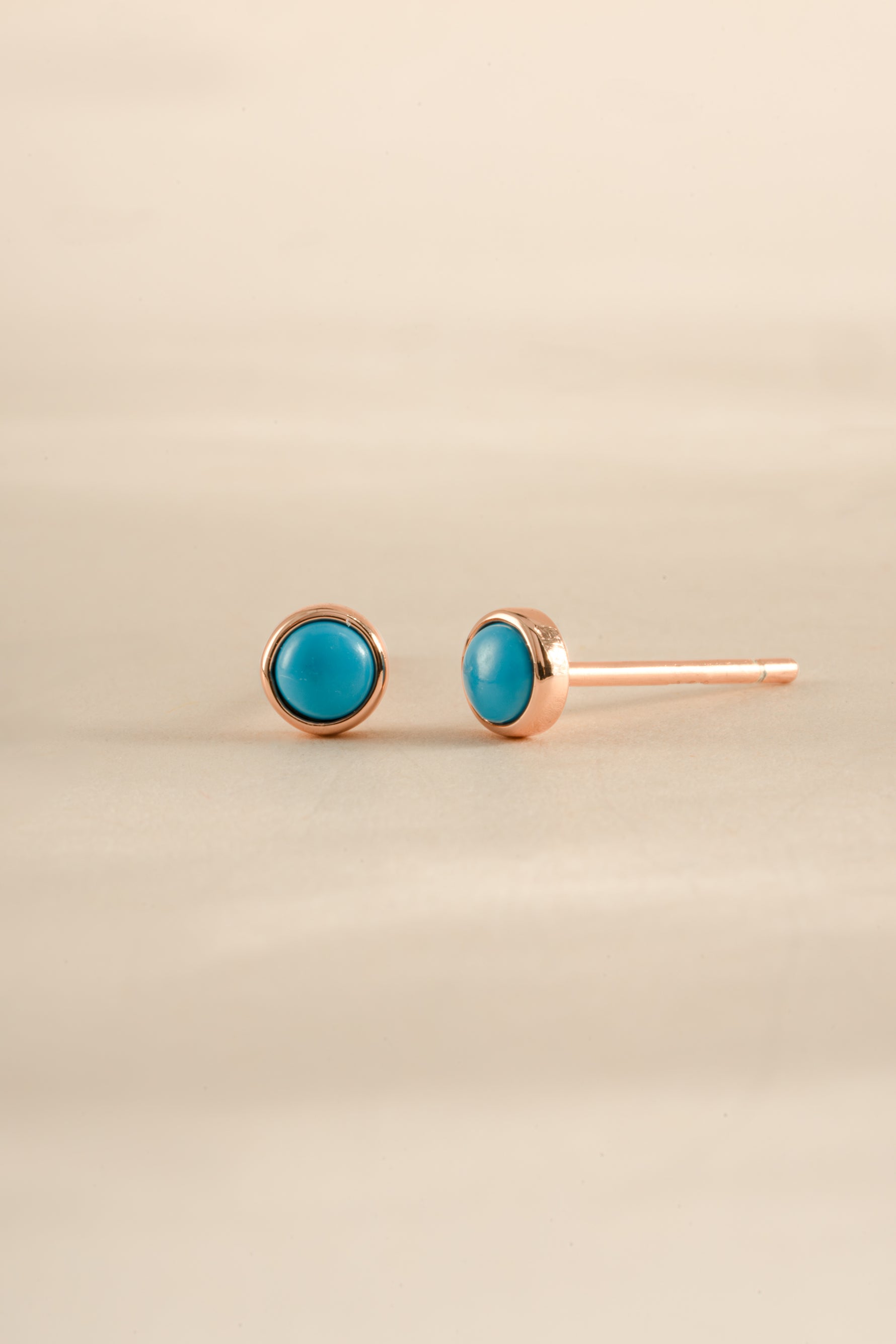 Sami Jewels turquoise stud earrings with rose gold setting, round gemstone design perfect for elegant jewelry styling.