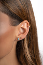 Sami Jewels turquoise stud earrings featuring vibrant turquoise stones set in sterling silver.