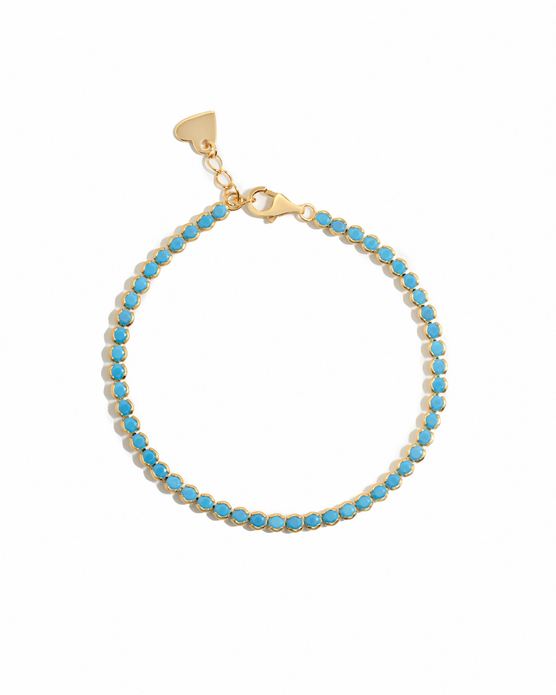 turquoise tennis bracelet in gold on a white background