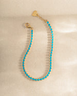 turquoise tennis bracelet in gold closeup