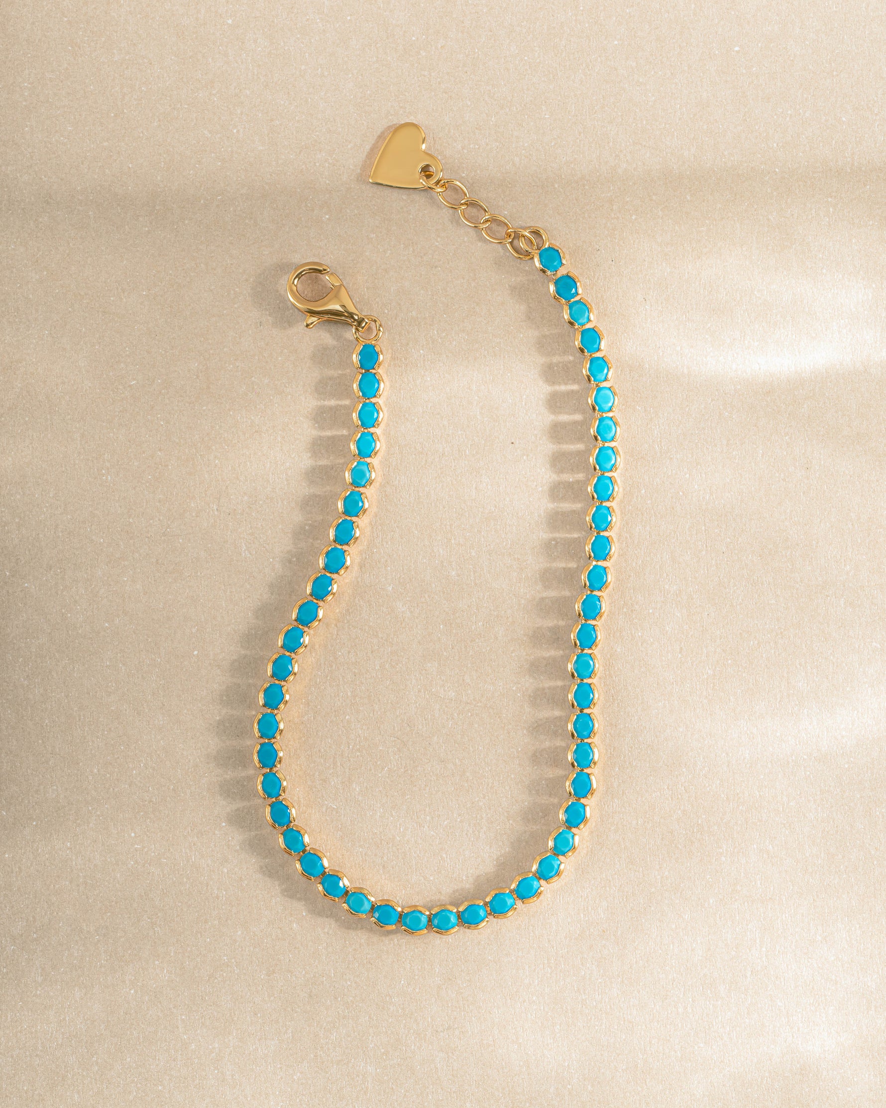 turquoise tennis bracelet in gold closeup