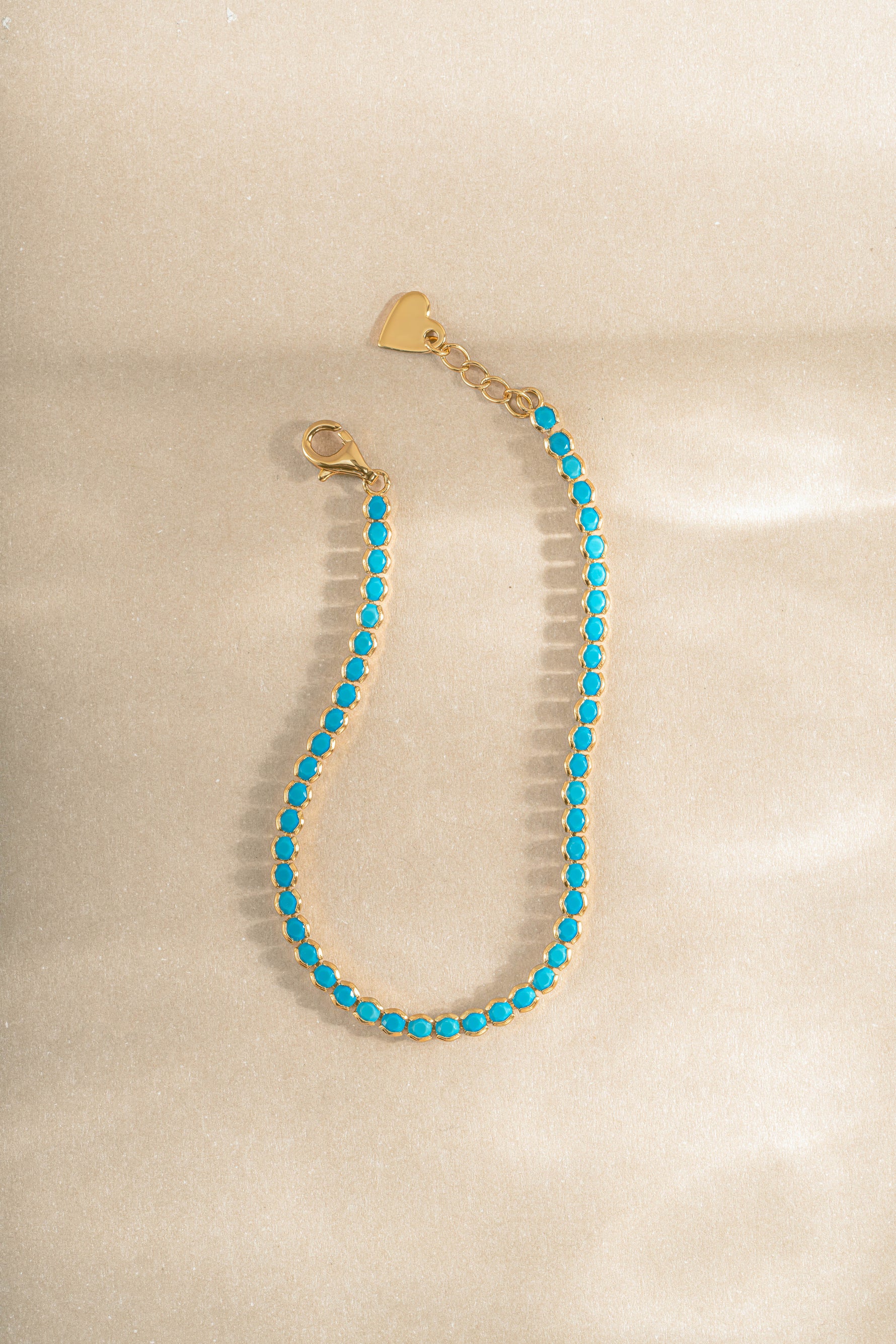 Sami Jewels 3mm turquoise tennis bracelet with gold links, showcasing vibrant turquoise stones on a delicate bracelet.