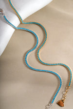 Close-up of Sami Jewels turquoise tennis bracelet with gold and sterling silver accents, showcasing vibrant turquoise stones and elegant design.