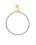 Turquoise tennis bracelet by Sami Jewels featuring vibrant turquoise stones set in gold on a white background.