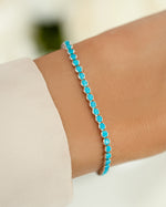 turquoise tennis bracelet in sterling silver on models wrist