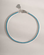 Turquoise tennis bracelet by Sami Jewels featuring sterling silver setting and vibrant turquoise stones.