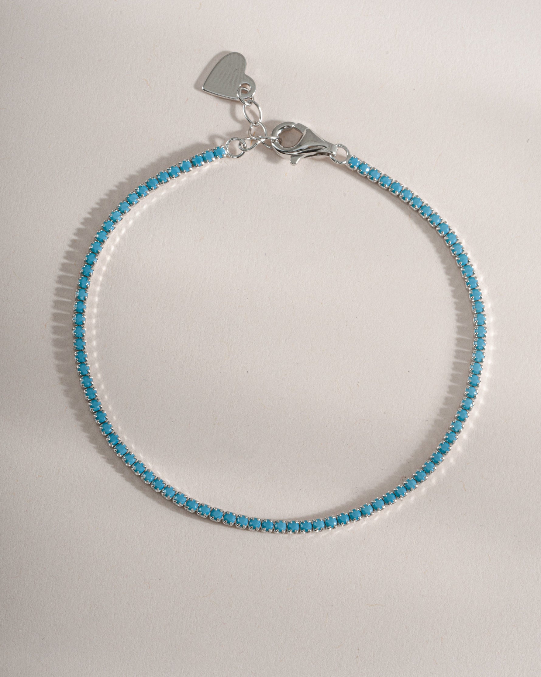 Turquoise tennis bracelet by Sami Jewels featuring sterling silver setting and vibrant turquoise stones.