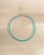 turquoise tennis bracelet in sterling silver on a simple background