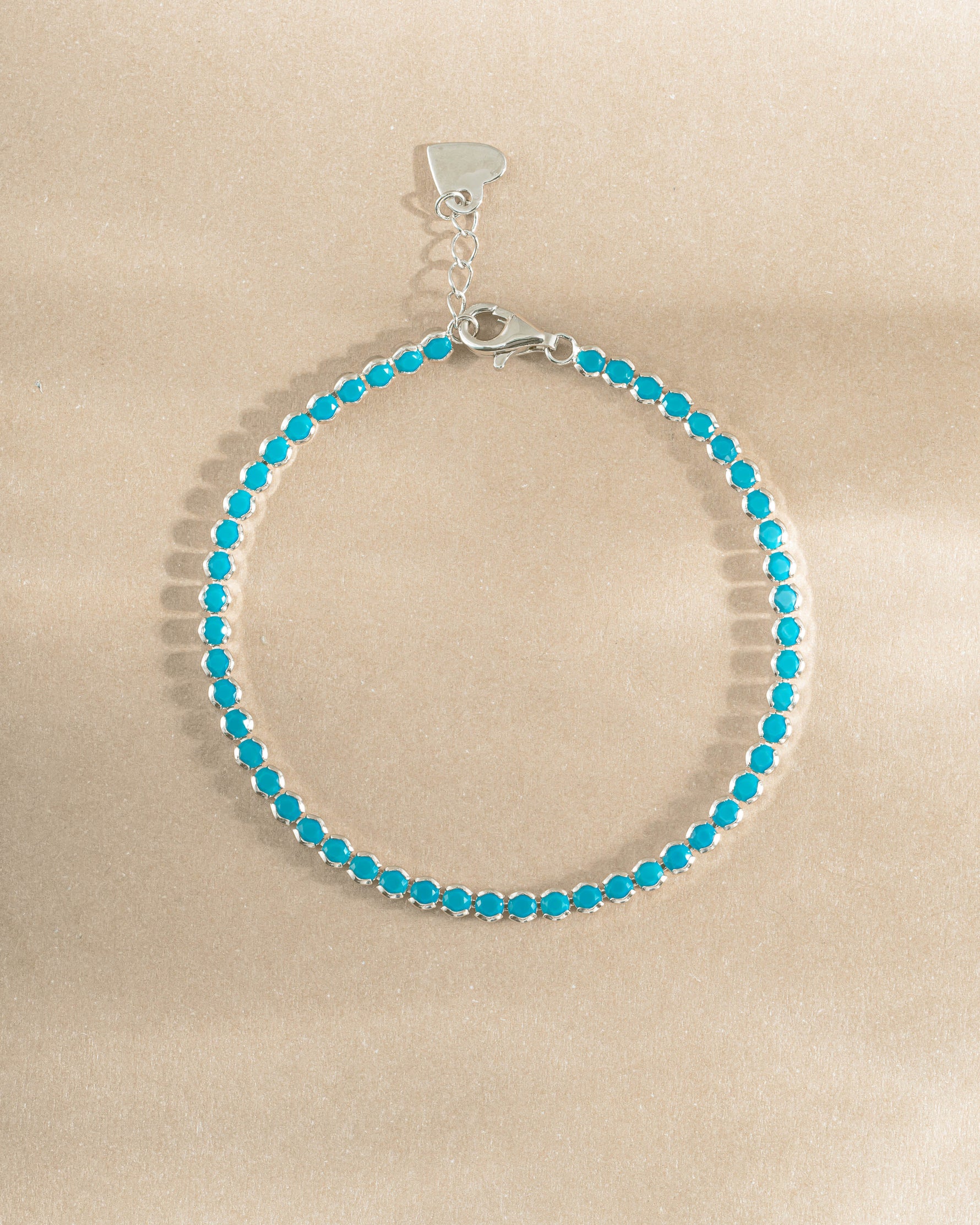 turquoise tennis bracelet in sterling silver on a simple background