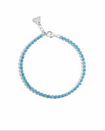 turquoise tennis bracelet in sterling silver on a white background