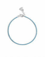 Turquoise tennis bracelet by Sami Jewels featuring sterling silver links on a white background.