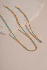 Turquoise bezel tennis jewelry set with matching necklace and bracelet by Sami Jewels featuring gold accents.