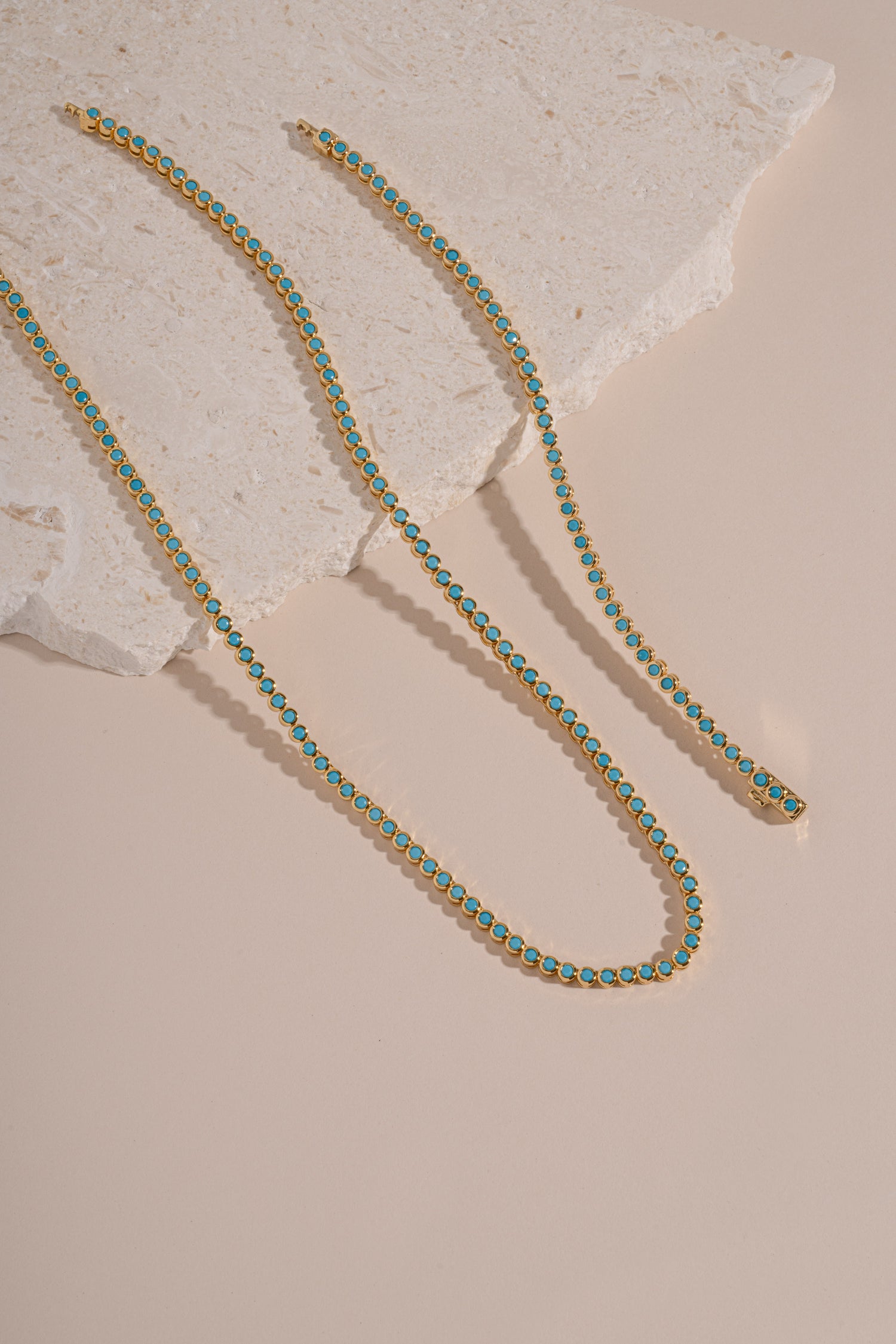 Turquoise bezel tennis jewelry set with matching necklace and bracelet by Sami Jewels featuring gold accents.
