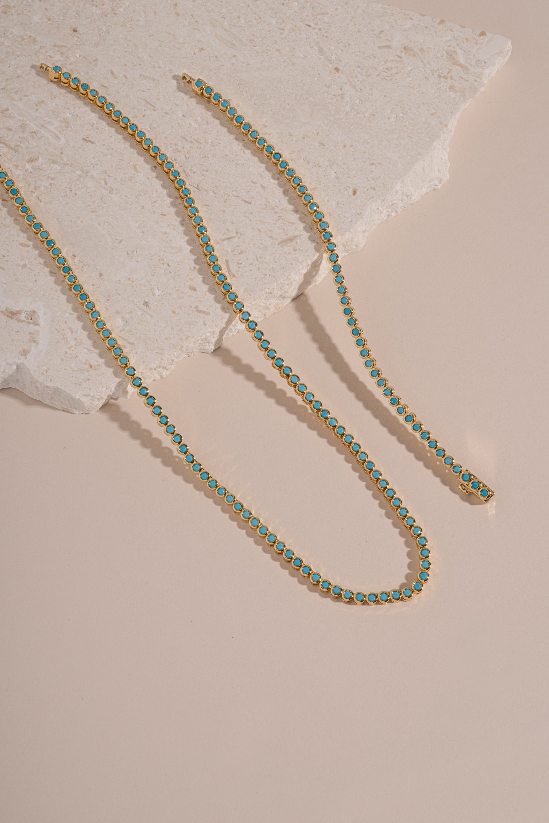 Turquoise bezel tennis jewelry set with matching necklace and bracelet by Sami Jewels featuring gold accents.