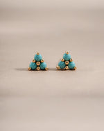 Gold earrings featuring turquoise three-stone studs from Sami Jewels, front view showing vibrant turquoise stones and elegant design.