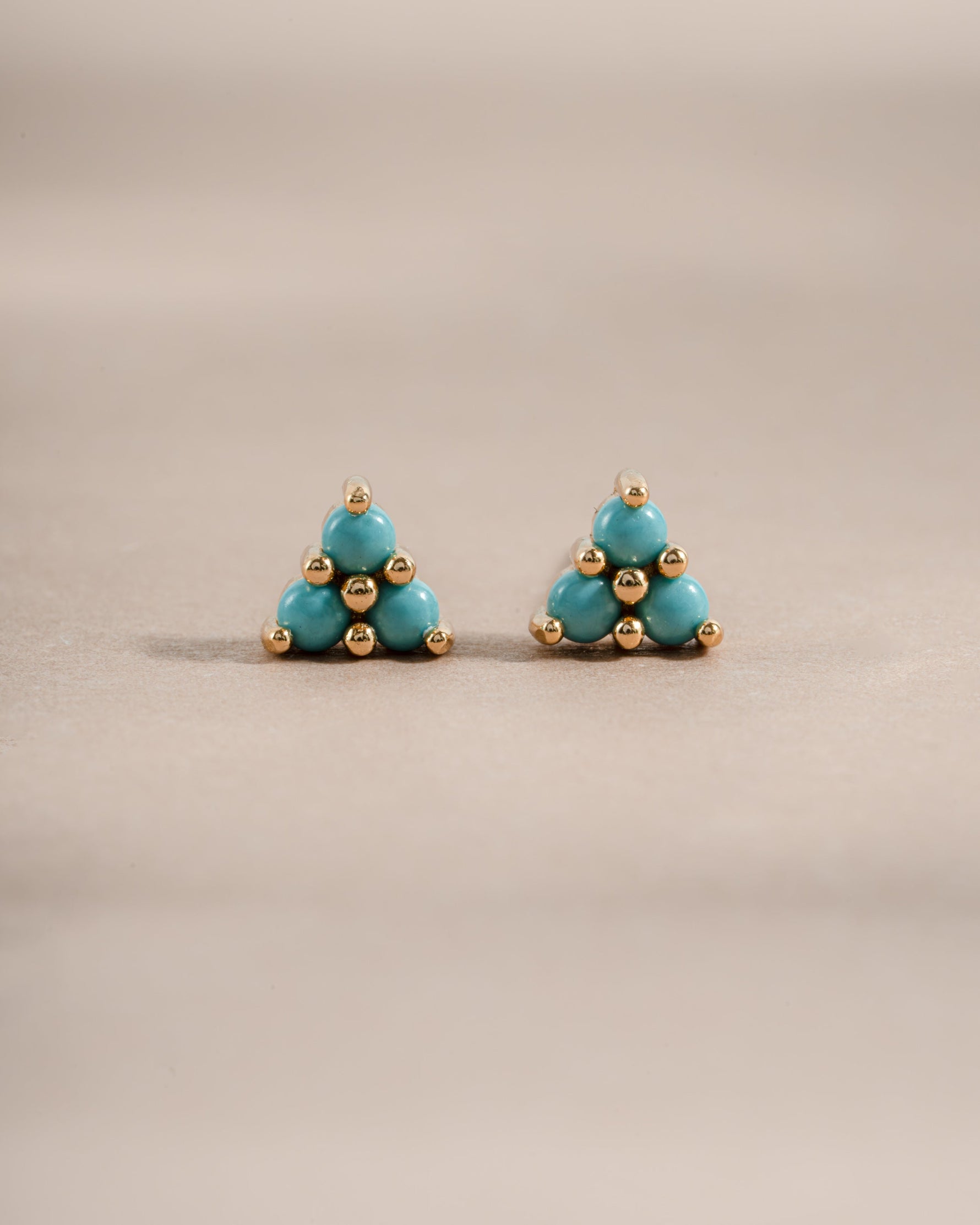 Gold earrings featuring turquoise three-stone studs from Sami Jewels, front view showing vibrant turquoise stones and elegant design.