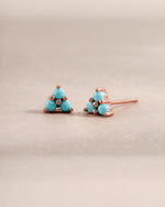 Turquoise three-stone stud earrings by Sami Jewels featuring rose gold setting and vibrant turquoise stones.