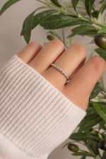 Sterling silver Twist Stacking Ring by Sami Jewels, featuring a sleek twisted design, worn as a stylish ring accessory.