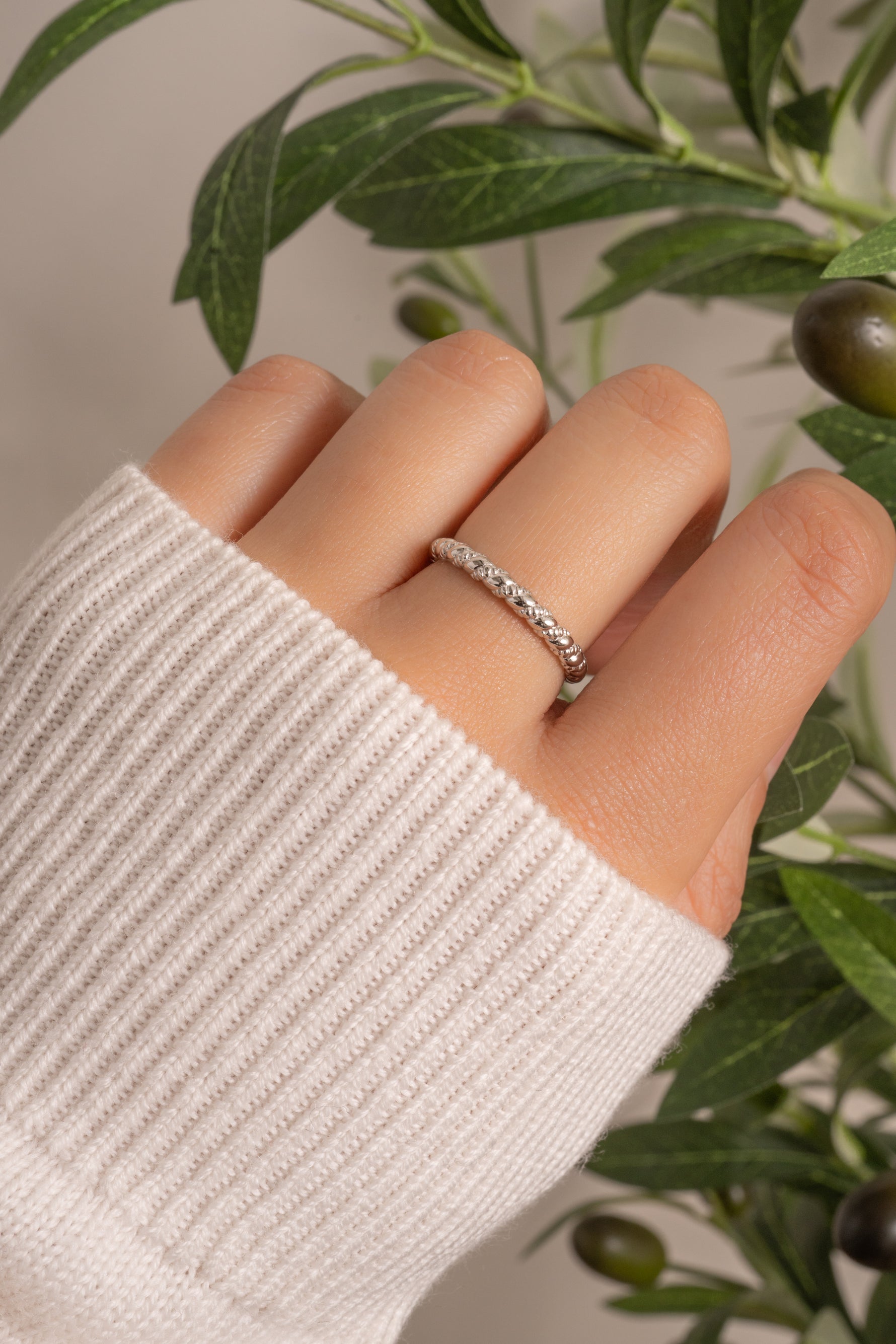 Sterling silver Twist Stacking Ring by Sami Jewels, featuring a sleek twisted design, worn as a stylish ring accessory.
