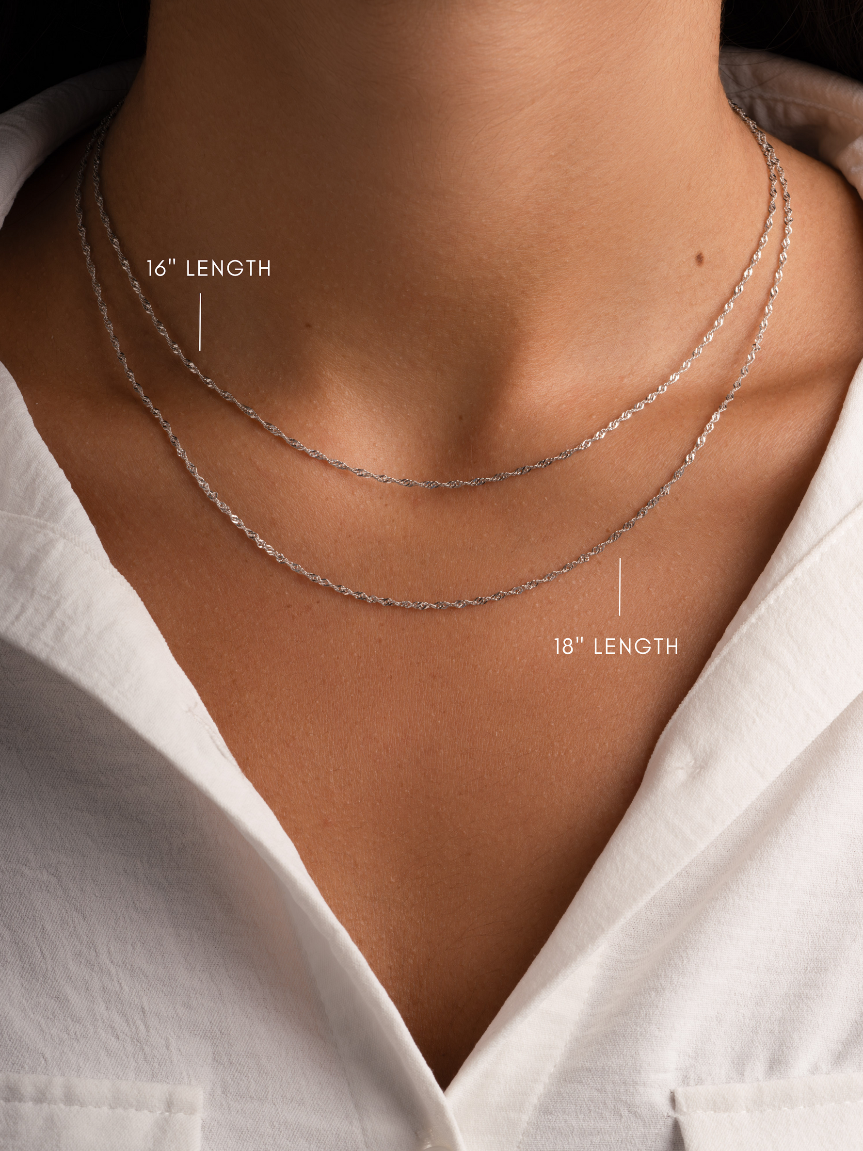 Sterling silver thin twisted chain necklace by Sami Jewels, shown layered on a model for a stylish, elegant look.