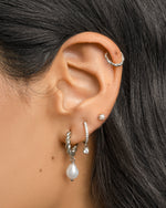 Sterling silver spiral pearl drop earrings by Sami Jewels featuring twisted hoop design with elegant pearl accents.