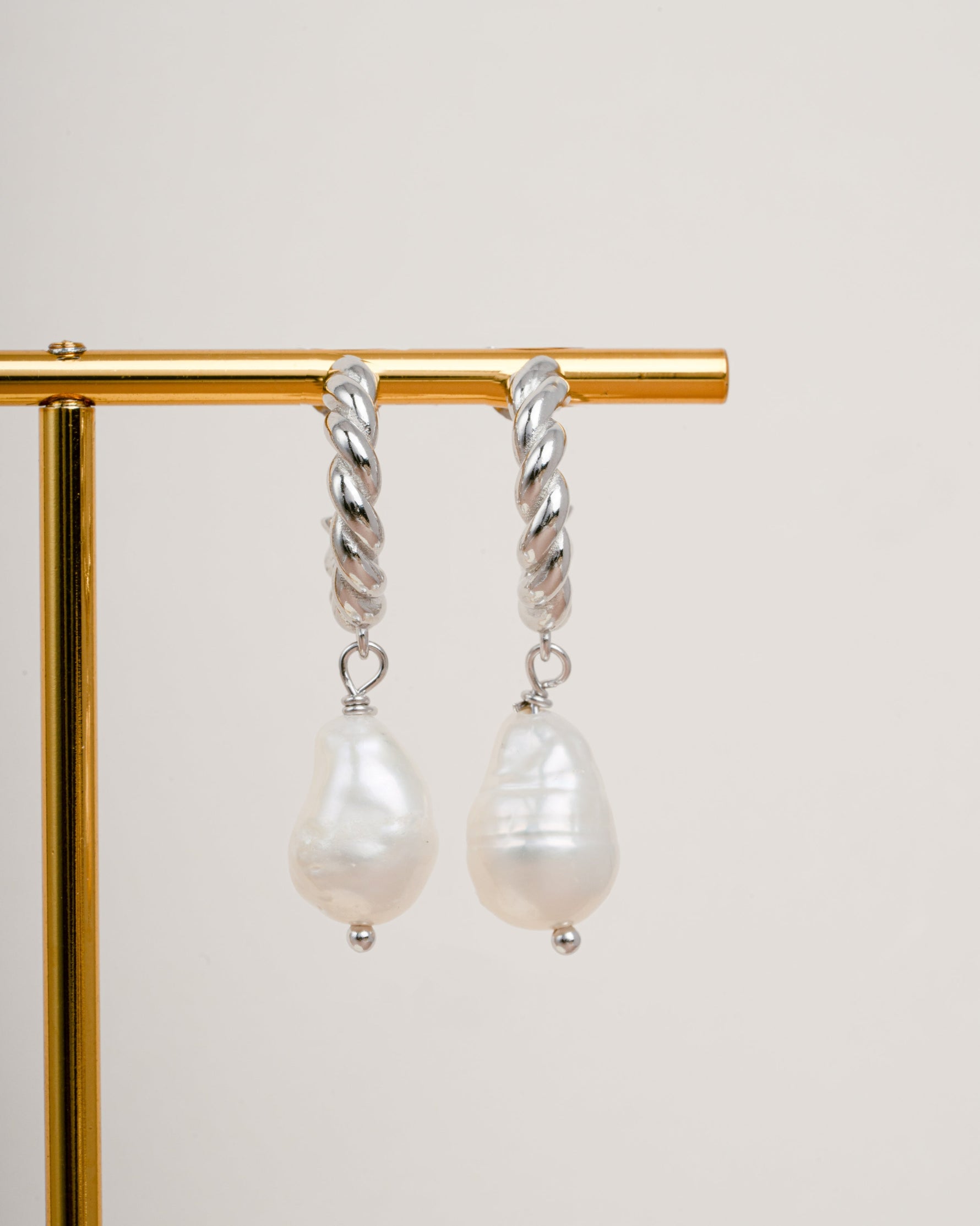 Sterling silver spiral pearl drop earrings by Sami Jewels featuring twisted hoop design and elegant pearl accents.
