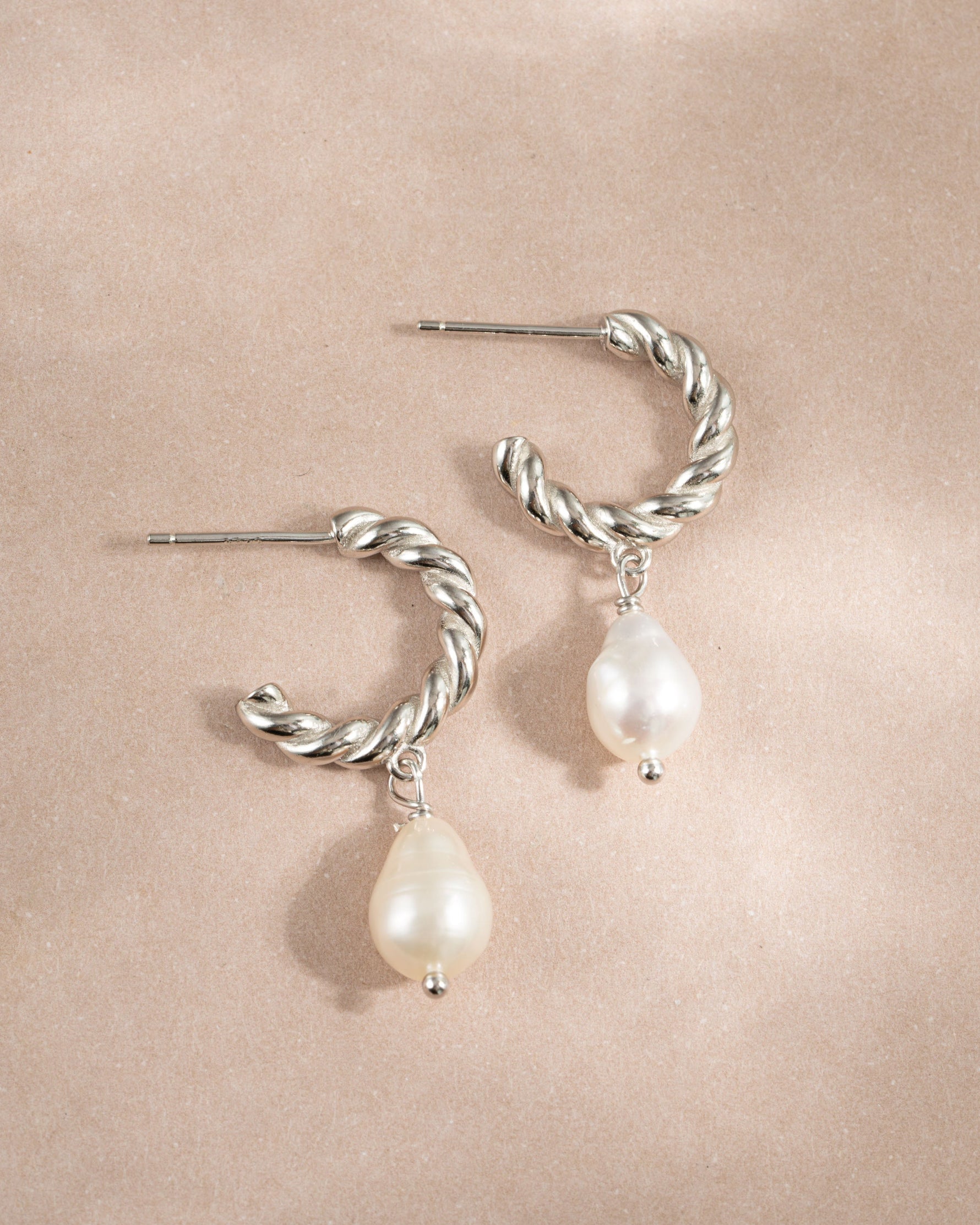 Sterling silver spiral pearl drop earrings by Sami Jewels featuring twisted hoops and elegant pearl accents.