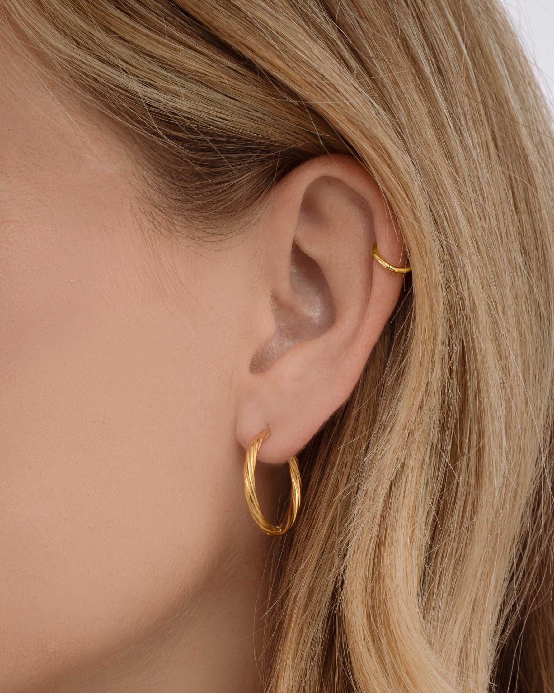 Gold stainless steel SS twisted hoops earrings by Sami Jewels, showcasing a sleek twisted design and waterproof finish.