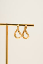 Close-up of Sami Jewels SS Twisted Oval Hoops earrings in gold stainless steel with a waterproof finish.