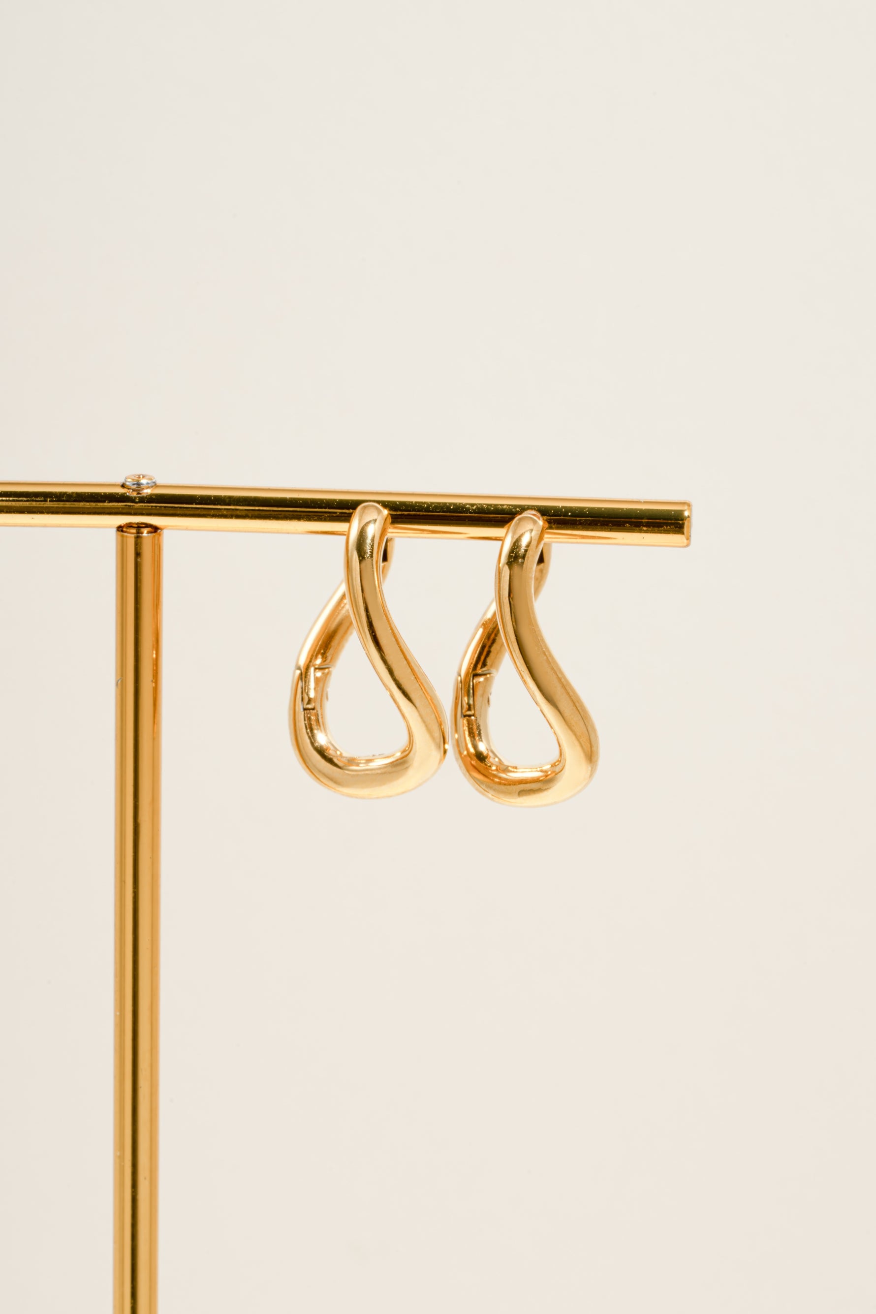 Close-up of Sami Jewels SS Twisted Oval Hoops earrings in gold stainless steel with a waterproof finish.