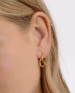 Gold stainless steel SS twisted oval hoops earrings by Sami Jewels, showcasing their elegant, twisted oval design and waterproof finish.