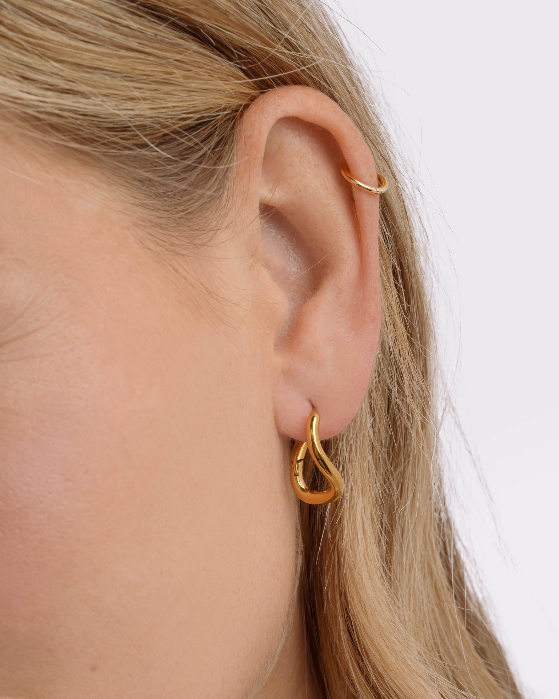 Gold stainless steel SS twisted oval hoops earrings by Sami Jewels, showcasing their elegant, twisted oval design and waterproof finish.