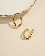 Gold stainless steel SS twisted oval hoops earrings by Sami Jewels, showcasing a sleek and waterproof design.