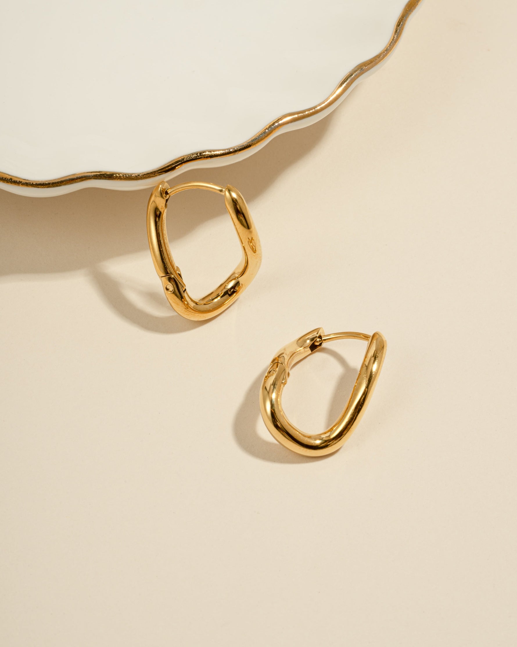 Gold stainless steel SS twisted oval hoops earrings by Sami Jewels, showcasing a sleek and waterproof design.