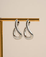 Silver stainless steel SS twisted oval hoops earrings by Sami Jewels, waterproof jewelry with sleek twisted design.