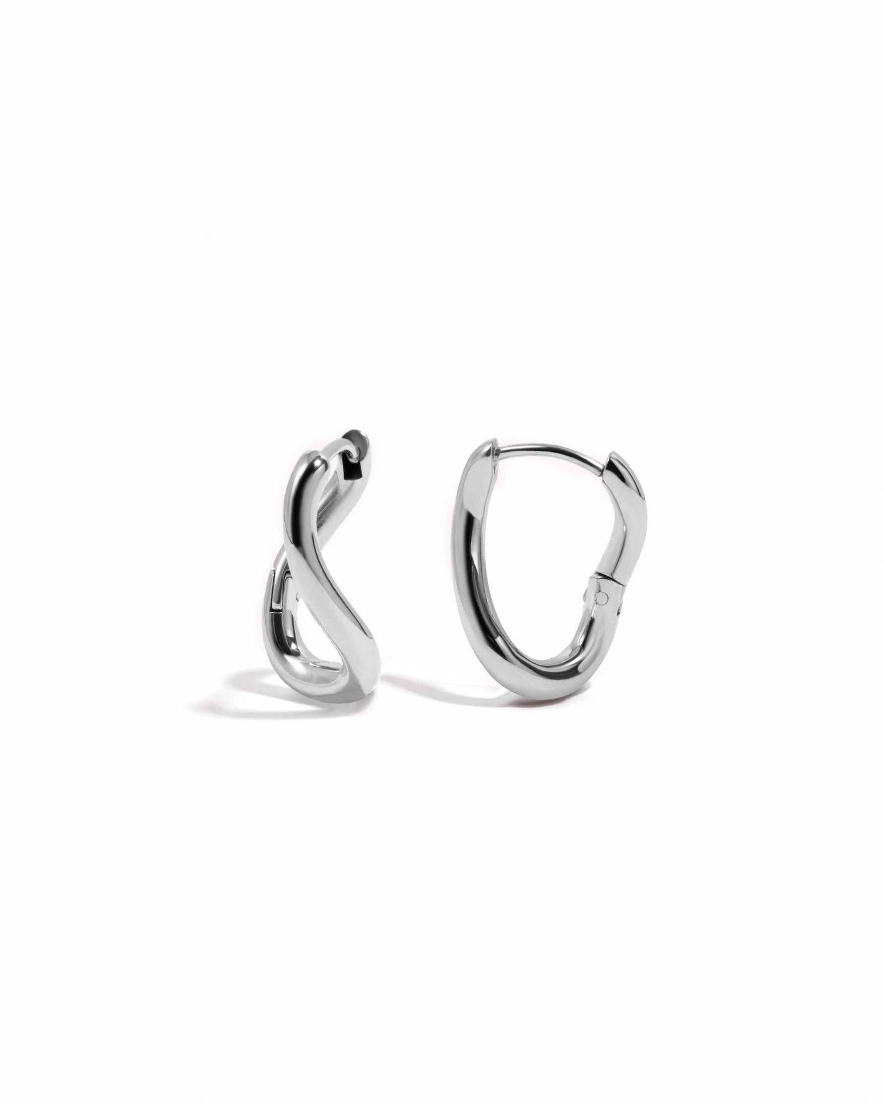 Silver stainless steel SS twisted oval hoop earrings by Sami Jewels, featuring a sleek, modern design and waterproof finish.