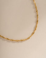 Close-up of a gold Thin Twisted Chain Necklace by Sami Jewels, showcasing its delicate twisted rope design.
