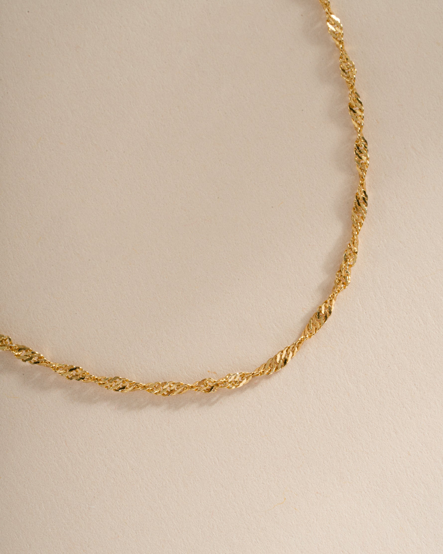 Close-up of a gold Thin Twisted Chain Necklace by Sami Jewels, showcasing its delicate twisted rope design.