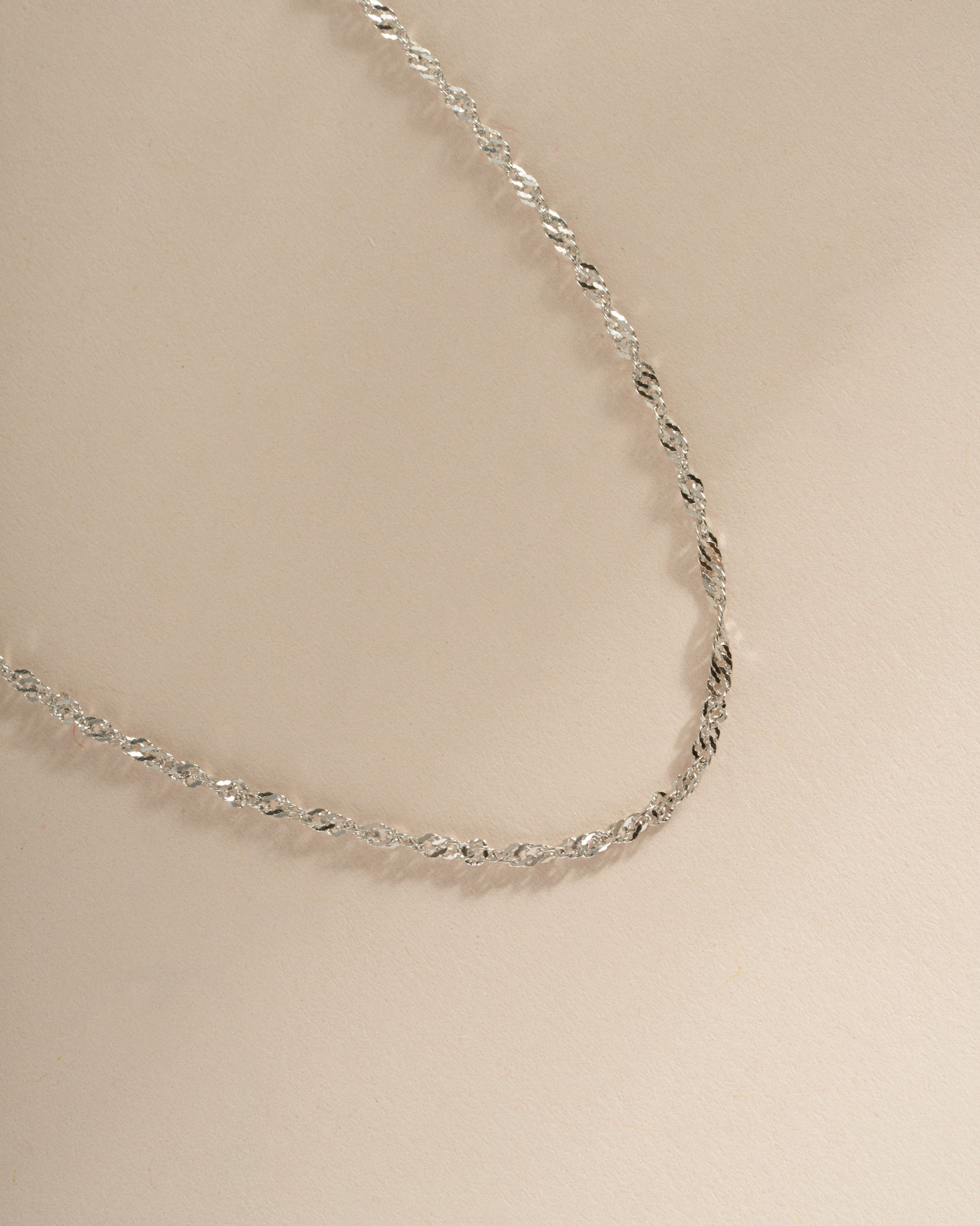 Close-up of a Sterling Silver Thin Twisted Rope Chain Necklace by Sami Jewels, showcasing its delicate twisted design.